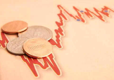 Coins on graph paper Stock Photos
