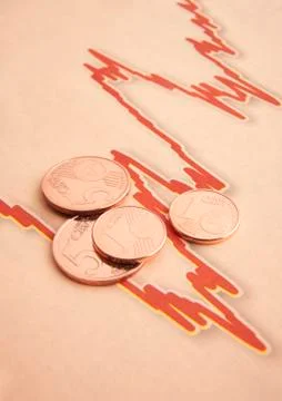 Coins on graph paper Stock Photos