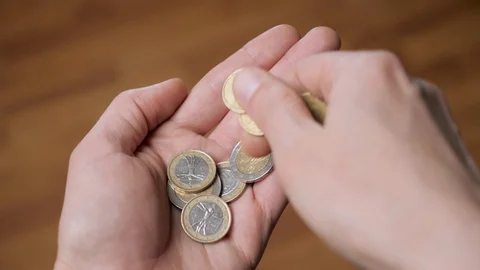 Coins in hand. Hands counting a few euro coins. A hand of coins in the palm Stock Footage 130153193