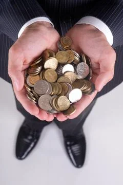 Coins in hand Stock Photos