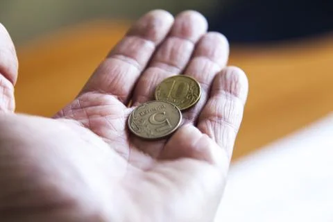 Coins in a hand Stock Photos
