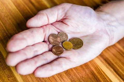 Coins in hand Stock Photos