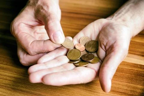 Coins in hands Stock Photos