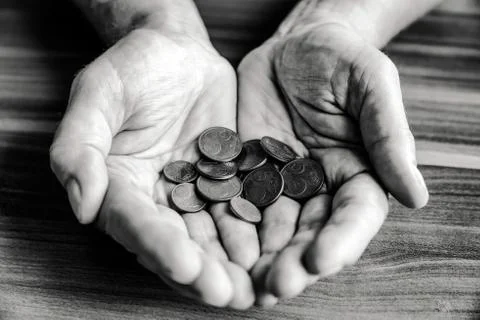 Coins in hands Stock Photos