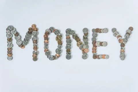Coins isolated on solid white background spelling the word Money Stock Photos