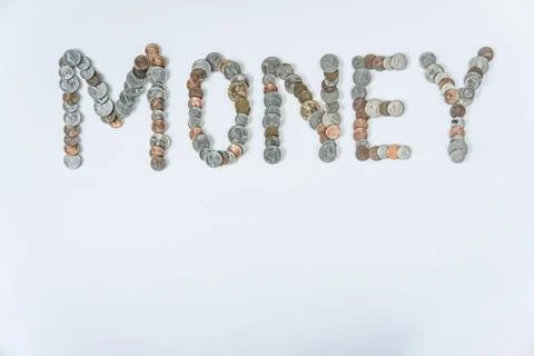 Coins isolated on solid white background spelling the word Money Stock Photos