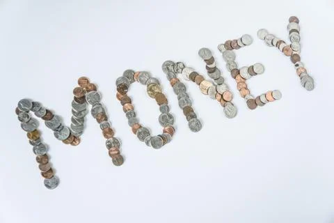 Coins isolated on solid white background spelling the word Money Stock Photos