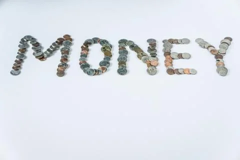 Coins isolated on solid white background spelling the word Money Stock Photos
