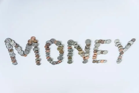 Coins isolated on solid white background spelling the word Money Stock Photos