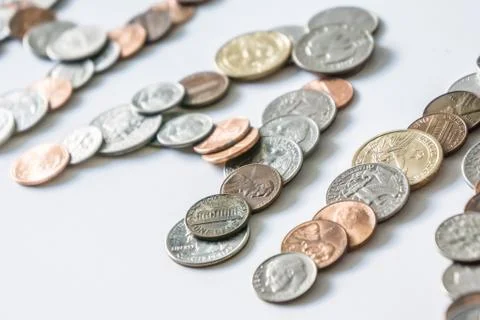 Coins isolated on solid white background spelling the word Money Stock Photos