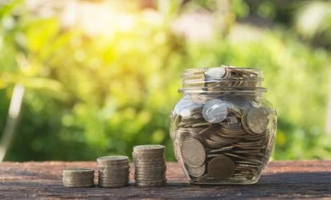 Coins in jar with money stack step growing money, Concept finance business an Stock Photos