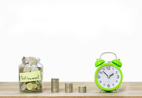Coins in jar with money stack step growing money and alarm clock. Stock Photos