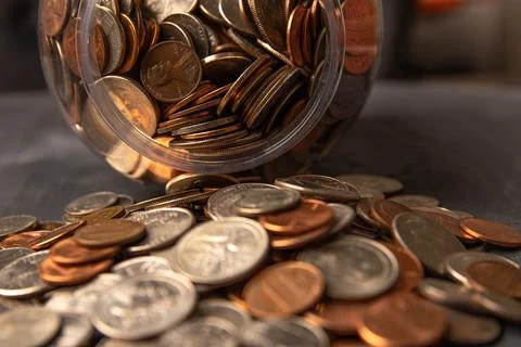 Coins in a jar Stock Photos