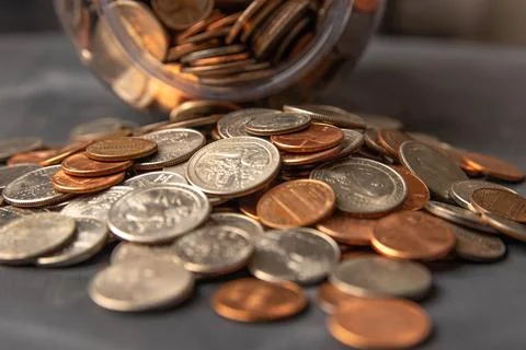 Coins in a jar Stock Photos