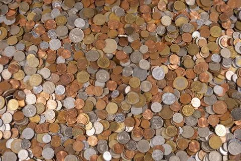 Coins laid out on a flat surface in a random arrangement Stock Photos