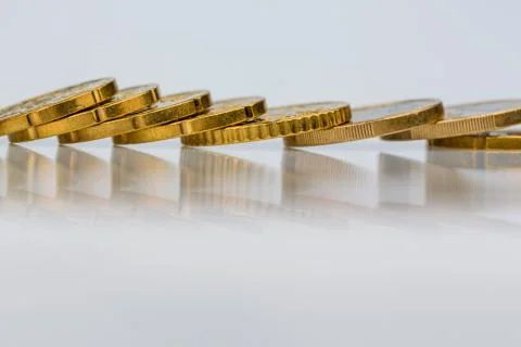 Coins lying in a row Stock Photos