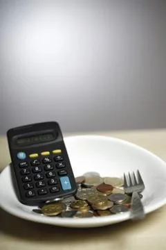 Coins on a plate Stock Photos