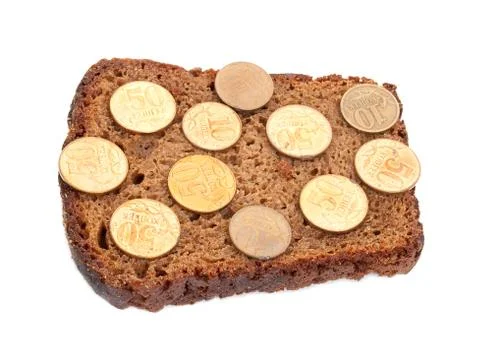 Coins on rye bread slice Stock Photos