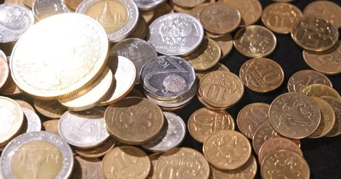 Coins scattered on rotating surface, abstract composition, euro, rubles, pennies Stock Footage 120894966