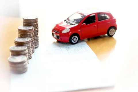 Coins stack in columns on saving book and car on finance concept Stock Photos