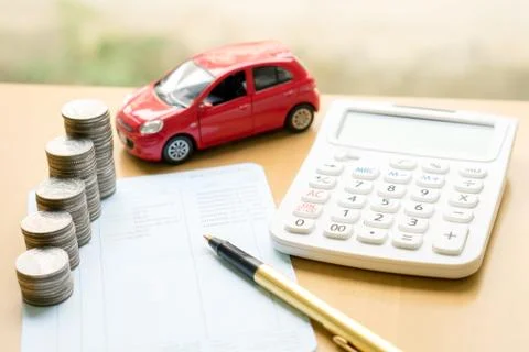Coins stack in columns on saving book and car on finance concept Stock Photos