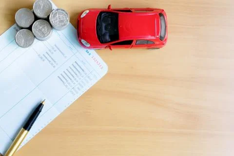 Coins stack in columns, saving book, car. Finance and banking concept. Foto stock