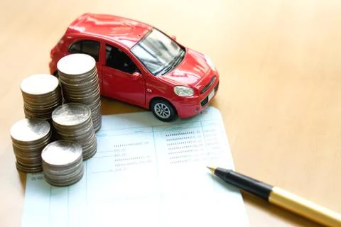 Coins stack in columns, saving book, car. Finance and banking concept. Stock Photos
