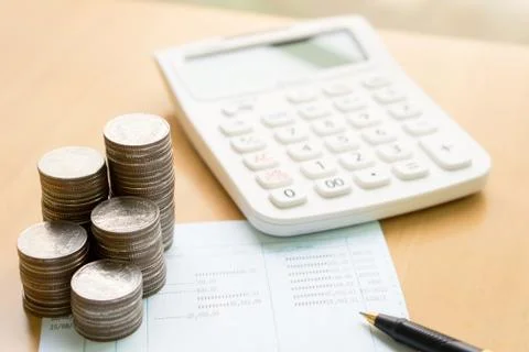 Coins stack in columns with saving book finance and banking concept for backg Stock Photos