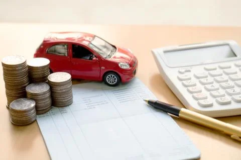 Coins stack in columns, saving book, car. Finance and banking concept. Stock Photos