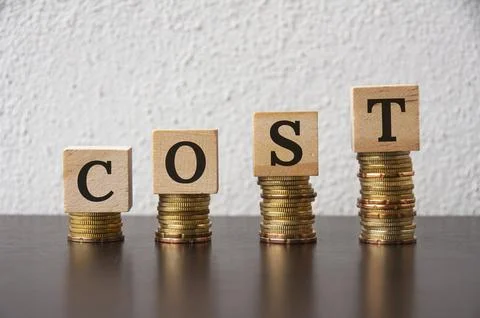 Coins stack with Cost text on wooden blocks - Financial Concept Stock Photos