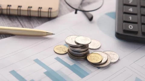 Coins stack on financial report with calculator and pen dynamic motion clos.. Stock Footage 332745596