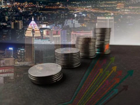 Coins stack increasing trend with trend line double exposure image with city 스톡 사진