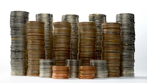 Coins on stack increasing on white background - stop motion. Stock Footage 137709910