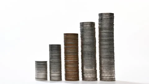 Coins on stack increasing on white background - stop motion Stock Footage 142268761