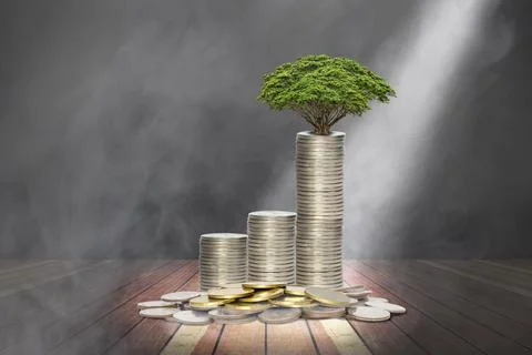 Coins stack with lighting and smoke on wooden stage,economic growth concept Foto stock