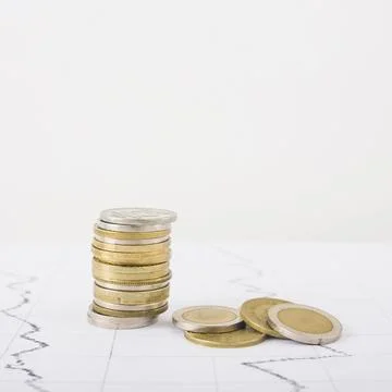 Coins stack white table 스톡 사진