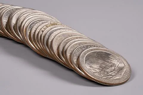 Coins stacked in a line on a flat surface in good light 写真素材