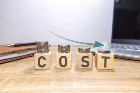 Coins stacking with the down arrow. Cost reduction concept. Stock Photos