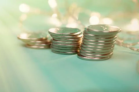 Coins in stacks on a uniform background Stock Photos