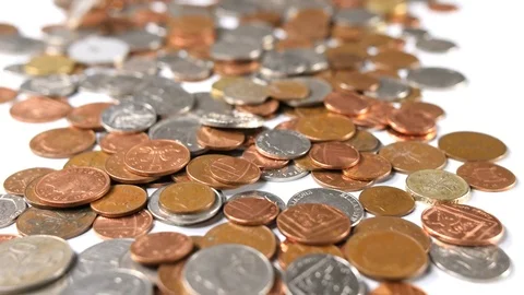Coins thrown onto a white background, close up of loose british copper Stock Footage 88517003