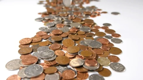 Coins thrown onto a white background, close up of loose british currency drop Stock Footage 88517038