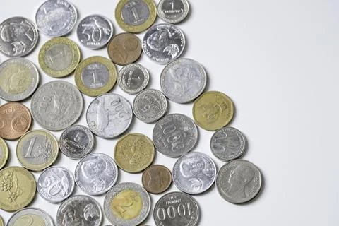Coins from various countries isolated on white background Stock Photos