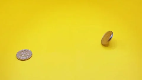 Coins on a yellow surface Stock Footage 333915132