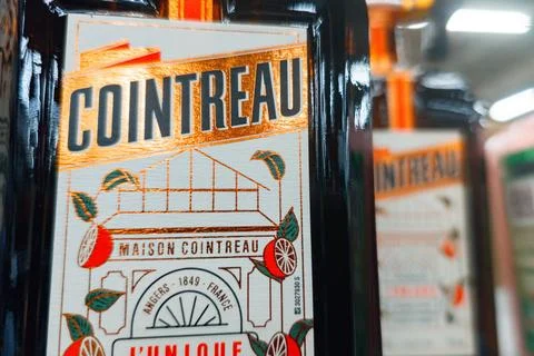 Cointreau bottle displayed in a store with bright label and design details 스톡 사진