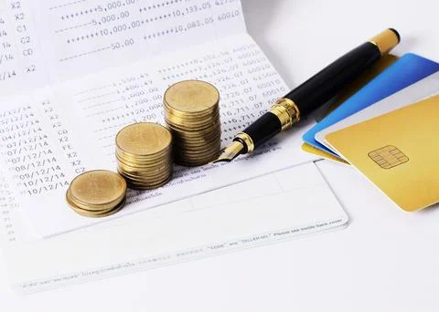 Cois stack and fountain pen with book saving backgrounds Stock Photos