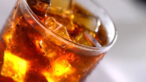 Coke with ice cubes background. Rotation... | Stock Video | Pond5