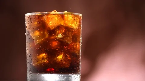 Coke with ice cubes background. Rotation... | Stock Video | Pond5