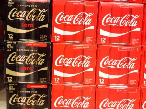 Coke zero classic coca cola cans cases stacked in supermarket background pattern Stock Photos