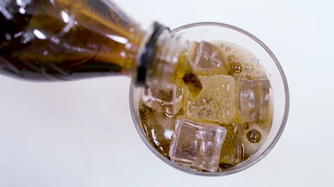 Cola Being Poured Over Ice in Glass Closeup Action Shot Stock Footage 340124291