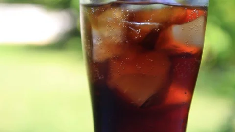 Cola bubbles in glass on nature background Stock Footage 119195780